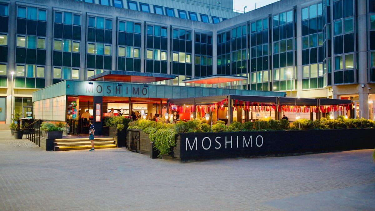 Moshimo at dusk in Bartholomew Square, the deck lit under bunting