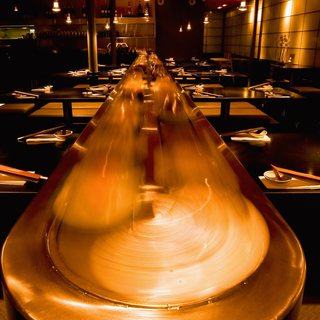 The conveyor belt glowing gold through the room