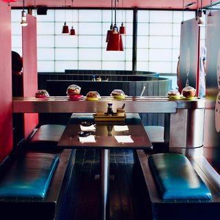 A booth by the belt under the red lamps